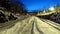 A perspective of the rails of a train station at dawn in northern Europe