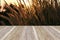 Perspective retro wood with grass petal sunset background