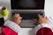 Perspective of Santa Claus Using laptop for communication and leisure, typing in keyboard, shopping online