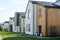 Perspective of several small two storey houses standing in front of green lawns