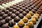 perspective shot of several unbaked chocolates aligned in rows