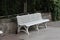 Perspective shot of urban white chair near stone wall in urban