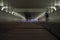 Perspective of an underground tunnel with silhouettes of people walking by