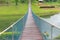 Perspective view of adventure wooden rope suspension bridge crossing river