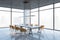 Perspective view on big conference wooden table surrounded by orange armchairs on grey glossy floor in spacious loft style meeting