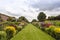 Perspective view of double herbaceous border in summertime.