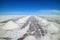 Perspective view of drying salt piles on Uyuni salt flats or Salar de Uyuni in Potosi, Bolivia