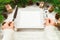 Perspective view girl holds fork and knife in hand and is ready to eat. Empty white square plate on wooden christmas background.