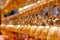 Perspective view group of small golden bells hang in Thai temple