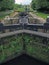 A perspective view of lock gates on the calder and hebble navigation canal at sowerby bridge in west yorkshire with town buildings