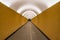 Perspective view of long modern futuristic yellow underground pedestrian tunnel in Stockholm Sweden.