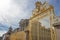 Perspective view of Main golden door and exterior fence at facade of Versailles Palace, Paris, France