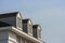 perspective view of modern gable roof design house wall with evening sky background.