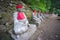 Perspective view, moss covered statues of Jizo in Nikko