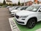 Perspective view of multiple cars on wide parking large space with Skoda Kodiaq white SUV as a test vehicle