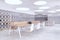 Perspective view of open space office coworking interior with comfortable workplaces, long wooden desk with laptops, concrete