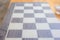 Perspective view and selective focus shot with copy space of vintage checkerboard shows beautiful pattern on square. It is