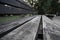 Perspective view of shabby planks of an old painted bench in a public park