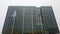 Perspective view of a skyscraper building with flags in front of it