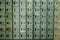 A perspective view of a stack of grey metal school lockers with combination locks