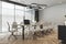 Perspective view on stylish lamp above light wooden meeting table with laptops, surrounded by chairs on parquet floor, light grey