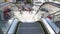 Perspective view thru escalator, defocused unrecognizable group of people on road intersection crosswalk on Strip of Las Vegas,