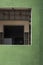 Perspective view of unfinished interior door and wall structure in window frame on curve green wall of modern house