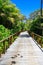 Perspective of wood bridge in deep tropical forest.