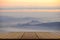 Perspective wood table with mountain and the mist view.