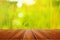 Perspective wooden table on nature field of green grass blur background