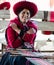 Peru, lady weaver, poses at her loom while weaving native garments