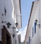 Peru, May, Cusco white walls, blue rectangular framed windows, walls converge to narrow opening to blue sky