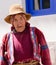 Peru native, old man dressed in colourful embroidered cest with hat and scarf around head