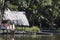 Peru Tingo Maria picturesque lagoon of miracles in the Amazon jungle with wooden houses thatched roofs on the palafitos river with