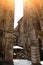 Perugia, Umbria, Italy. August 2020. In an alley in the historic center, an arch connects two tall medieval buildings. People