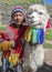 A Peruvian boy with a llama near Cusco in Peru.