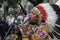 Peruvian busker, street musician, in national clothes playing the native wind instrument on a street