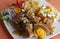 Peruvian food, Chicharron (fried pork) with potatoes, onion garnish, canchita.