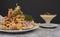 Peruvian food: Jalea de pescado or fish cracklings with fried cassava and onion salad with chili, served on a white plate. Fried