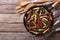 Peruvian Food: Lomo saltado in a frying pan. horizontal top view