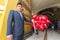 Peruvian man holding balloons during church ceremony, Trujillo