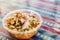 Peruvian mixed ceviche with red onion and fried corn at a street food market