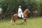 : Peruvian Paso horses being ridden by men in traditional clothing in Trujillo, Peru