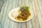 Peruvian recipe of roast duck with rice and white bean stew with purple onion