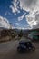 Peruvian typical car motorcycle in the foreground in Andean town with long street in the background and mountains