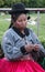 Peruvian woman knitting in a park