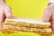 Pesach matzah in the hands of a man on a yellow background