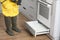 Pest control worker spraying pesticide in kitchen, closeup