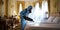 Pest controller works in a French hotel bedroom exterminating bedbugs