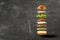 Pesto burger ingredients floating, grey plaster background, isolated, horizontal